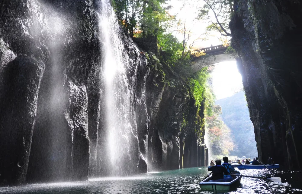 Rowing through Takachiho Gorge, one of the stunning Kyushu Hidden Gems